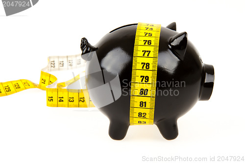 Image of Black piggy bank with measuring tape