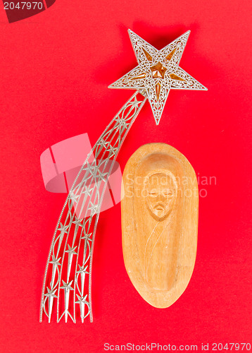 Image of Falling star, christmas decoration and a carving of the baby Jez