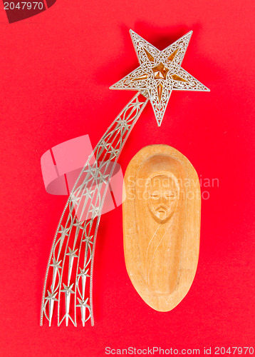 Image of Falling star, christmas decoration and a carving of the baby Jez