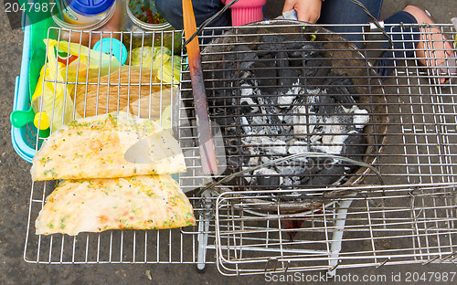 Image of Rice paper meal being made on a barbeque