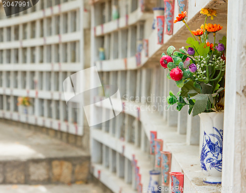 Image of Collection of fake plastic flowers at a cemetary