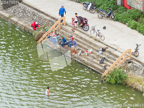 Image of DONG HOI, VIETNAM - AUGUST 7, 2012. Unidentified people are fish