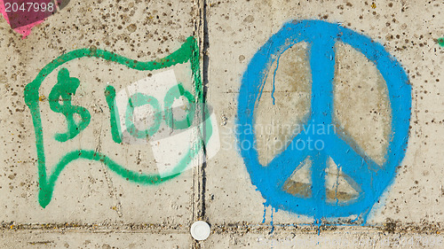 Image of Simple graffity on a concrete wall, dollar and piece sign