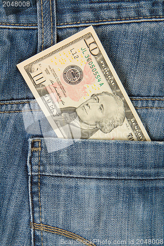 Image of Macro shot of trendy jeans with american 10 dollar bill