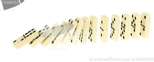 Image of Long train of dominoes falling over