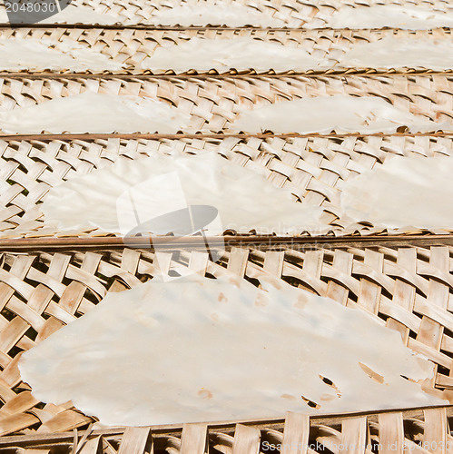 Image of Rice paper drying at a bamboo frame 
