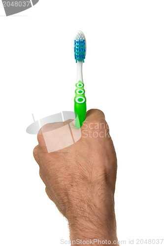 Image of Man holding a green toothbrush