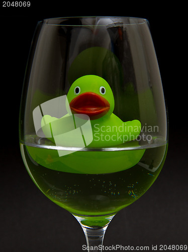 Image of Green rubber duck in a wineglass