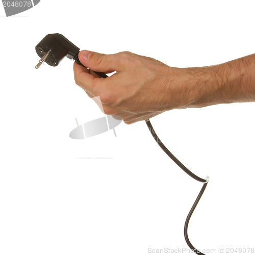 Image of Hand holding a plug in