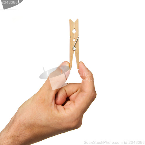 Image of Hand holding clothes peg