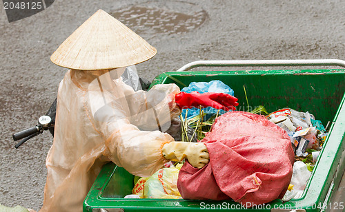 Image of DA LAT, VIETNAM - 28 JULY 2012: Government worker separates the 