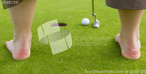 Image of Golf player hitting the ball