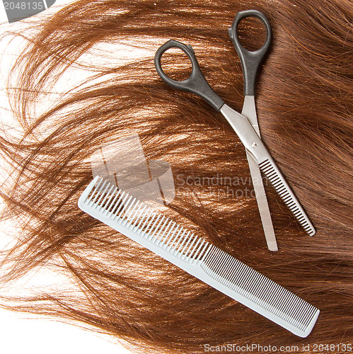 Image of Brown hair and hairdresser's tools