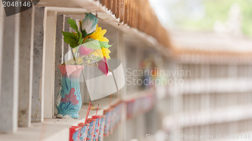 Image of Collection of fake plastic flowers at a cemetary