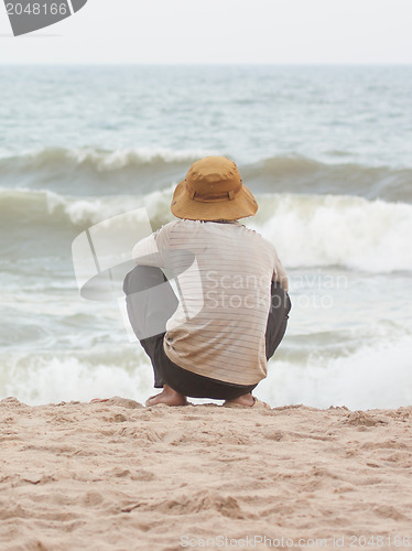 Image of Man sitting on the beach at the south chinese sea 