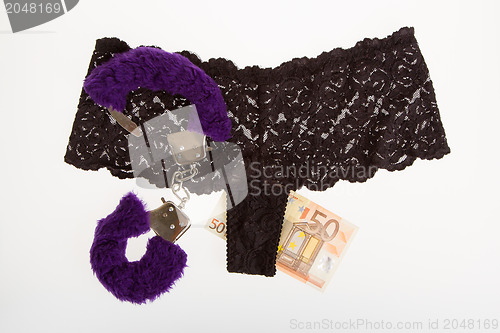 Image of Fluffy purple handcuffs, panties and money, prostitution