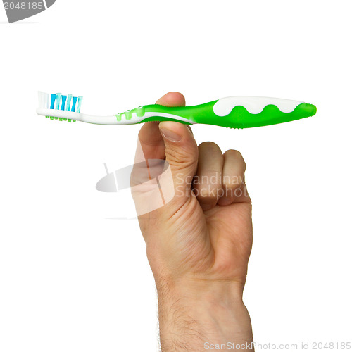 Image of Man holding a green toothbrush