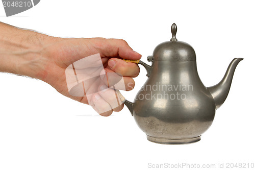 Image of Very old tin tea pot full of scratches