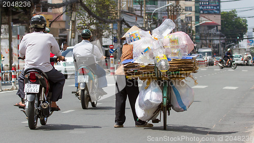 Image of HUE, VIETNAM - JULY 25, 2012. Vietnamese woman packed her posses