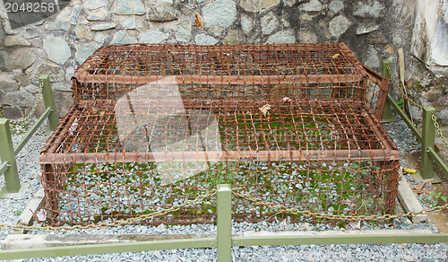 Image of Two Tiger Cages used in the Vietnam war on display in a museam i