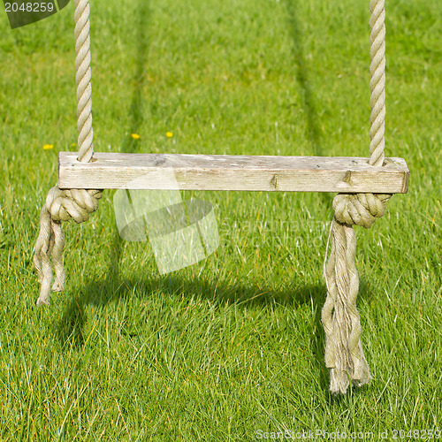 Image of Old wooden tree swing