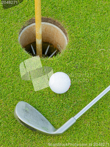 Image of Golf hole with ball and putt