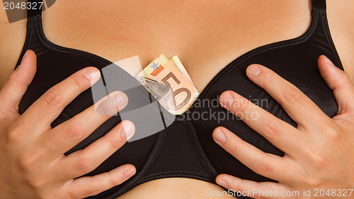 Image of Concept - woman with cash in a bra