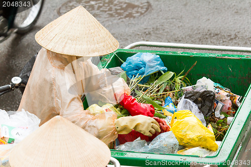 Image of DA LAT, VIETNAM - 28 JULY 2012: Government worker separates the 