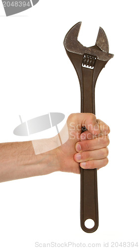 Image of Old rusted adjustable vector wrench in a hand