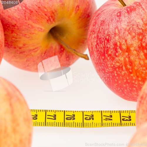 Image of Red apples with a yellow tape-measure