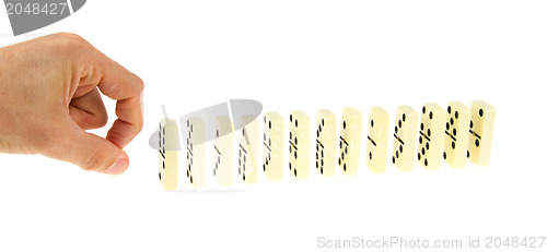 Image of Hand ready to push dominoes