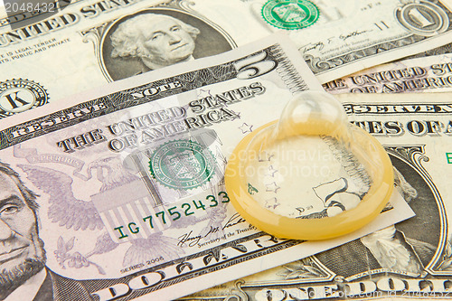 Image of Condom on the US dollars bills
