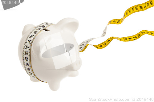 Image of White piggy bank with measuring tape