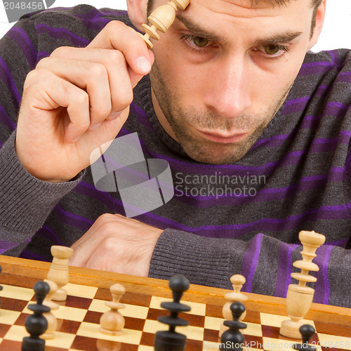 Image of Chessboard with desperate man thinking about chess strategy, iso