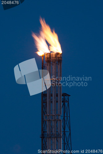 Image of Burning oil gas flare during the night 