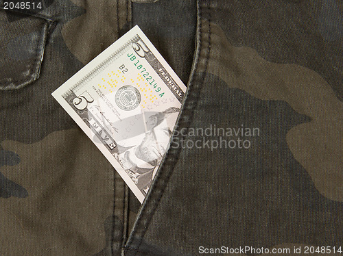 Image of Macro shot of trendy jeans with american 5 dollar bill