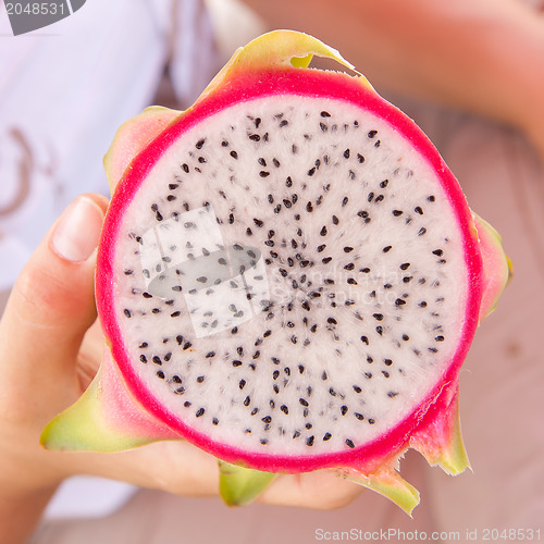 Image of Woman holding a dragon fruit