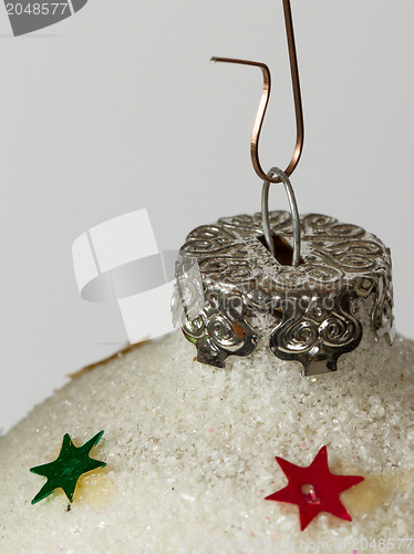 Image of Close-up of a silver christmas ball with stars