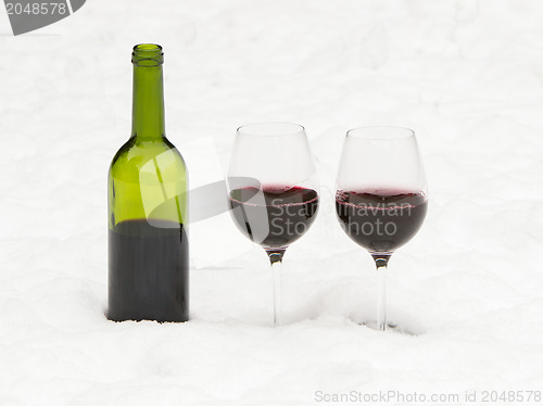 Image of Bottle of red wine and wineglasses isolated