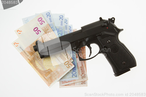 Image of Semi-automatic gun and money isolated