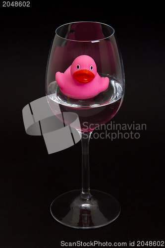 Image of Pink rubber duck in a wineglass