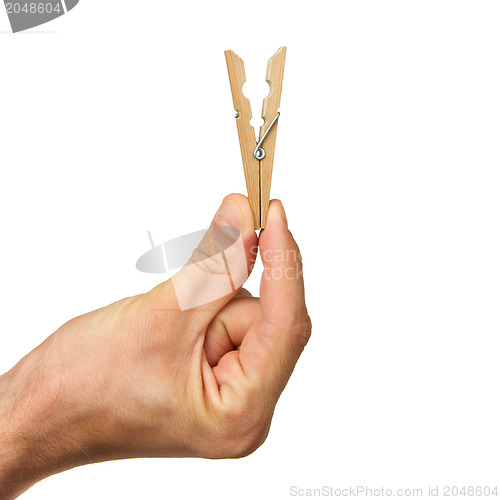 Image of Hand holding clothes peg
