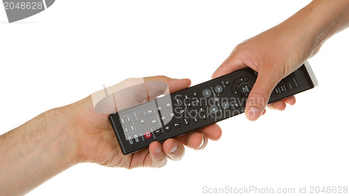 Image of Man giving woman a black remote