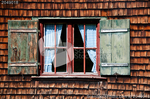 Image of Ancient window on log house wooden wall