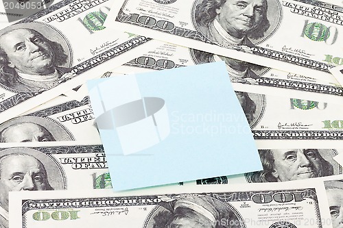 Image of Note paper on dollars background