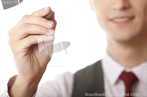 Image of Young businessman is writing on a virtual whiteboard