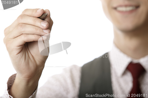 Image of Young businessman is writing on a virtual whiteboard