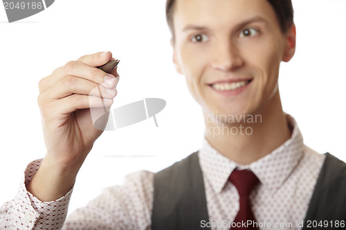 Image of Young businessman is writing on a virtual whiteboard