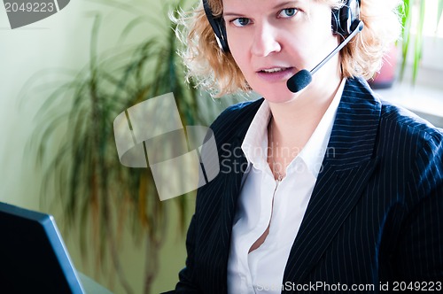 Image of Business woman with laptop and headset