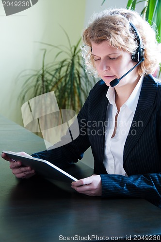 Image of Business woman with digital tablet PC and headset